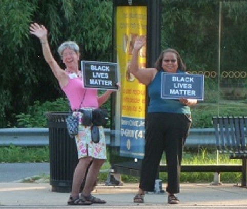 Two women holding signs that reads 'Black Lives Matter'